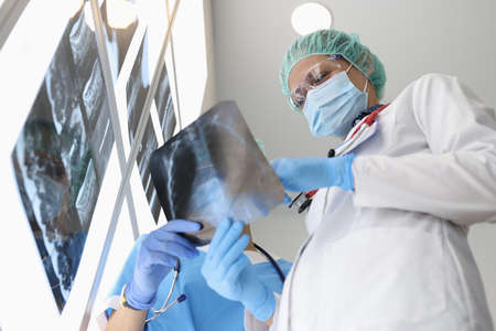 Doctors examine an X-ray when discussing it. Examination of internal organs and making a diagnosis