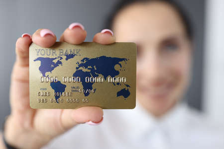 Bank credit card on background of smiling woman. Issuance of loans for the population concept