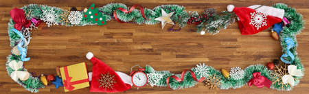 Christmas closeup background frame on wooden background. New year celebration complimentary template ticket and invitation card conceptの写真素材
