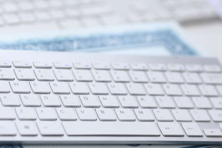 Close-up modern computer keyboard lies on document. User work tool with laptop. Care and...
