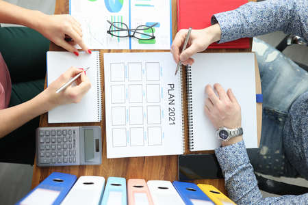 Man and woman are discussing a business plan for 2021. Business planning and development conceptの写真素材