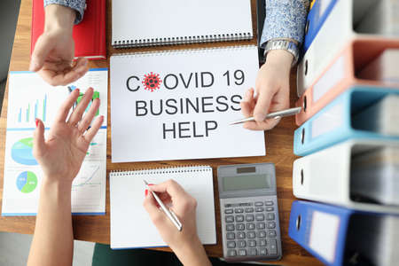 Man and woman discussing business plan coronovirus pandemic. State assistance to small and medium-sized businesses in pandemic conceptの写真素材