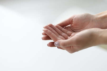 Womans hands are joined together on light background. Services of wellness medical centers conceptの写真素材