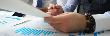 Two business partners looking at financial graph while examining the situation on the market