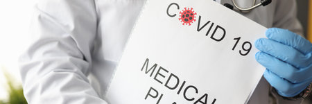 Infectious disease doctor holding covid 19 document medical plan closeup. Postpandemic health...
