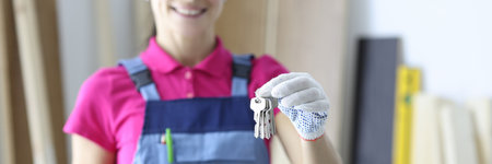 Builder holds keys and a clipboard in his hands. Receiving apartment keys conceptの写真素材