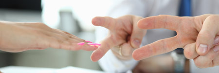 Close up of three colleagues hands while they are solving company problems using game in office