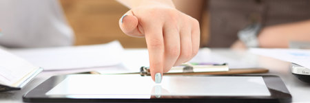 Close up cropped head of female touching gadget screen while having meeting at work