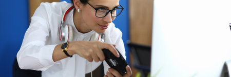 Beautiful businesswoman in white shirt and glasses play computer game. Woman hold joystick in her...