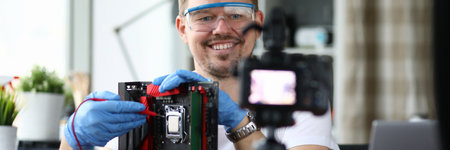 Blogger in goggle shoot training video on camera. Man conduct online master class and solder...