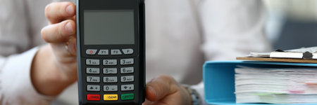 Office worker shows the terminal. Banking application. Paying for services through online bankingの写真素材