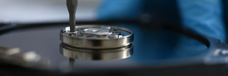 Close up of screw being screwed into metal part with a screwdriver. Repair concept. Mechanic or...