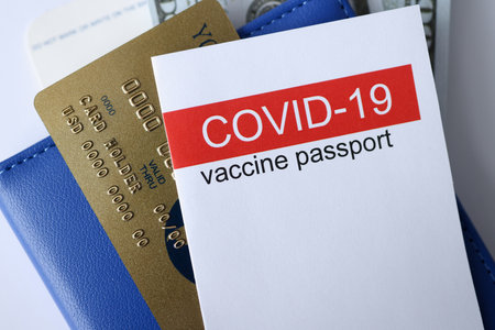 Closeup of covid 19 vaccination passport and credit bank card. Traveling during pandemic covid19...