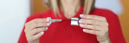 Master holds lock and key in his hands. Lock picking service conceptの写真素材
