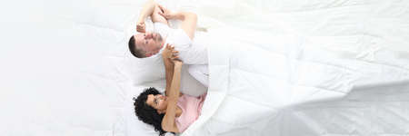 Man and woman swear in bed. Family psychology concept