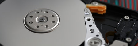 Hard disk is on table at repair service closeup. Information recovery and database concept.