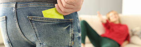 Man takes condom out of his pocket woman opposite stretches out her hand to him. Compliance and closeness between conceptの写真素材