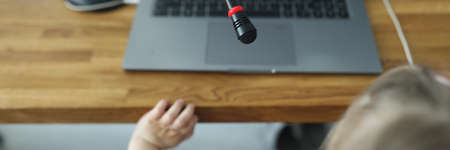 Girl sit on chair and play online game with broadcast. Watch video online. Make calls online. Application for communicating with people online. Streaming - media of the future. Real-time transfer of your video stream to other users.の写真素材