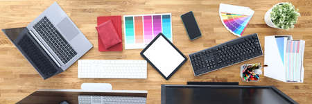 Workplaces in office table chairs tablet smartphone color palette pencils tablet keyboard monitors. Workplace layout conceptの写真素材