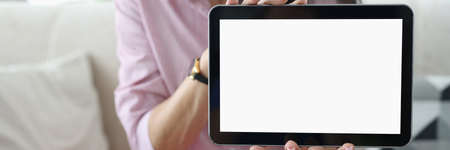 Woman holds black tablet in her hands. Review of technique by blogger concept