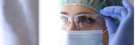Portrait of doctor in protective clothing mask and glasses. Protective clothing for infectious disease doctors conceptの写真素材