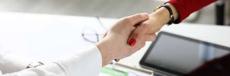 Female and male hands shake hands in office. Business agreements in marketing concept