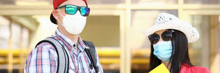 Young man and woman with passport and ticket in hand are waiting for the flight.