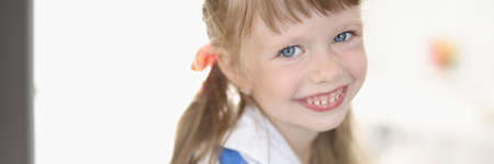 Little girl with blue eyes and blond hair portrait. Happy childhood conceptの写真素材