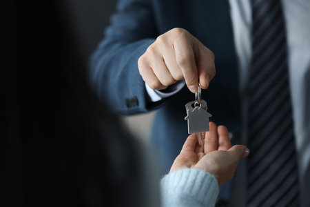 Businessman hands over house keys to clientの写真素材