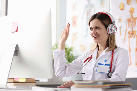 Doctor operator in call center at work desk
