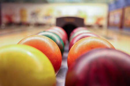 Colorful balls on rack in bowling club closeupの写真素材