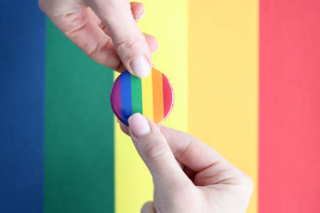 Lgbt sign in hands on background of flag