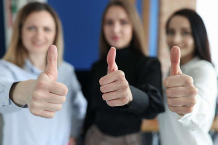 Three businesswoman are showing thumbs up gestureの写真素材