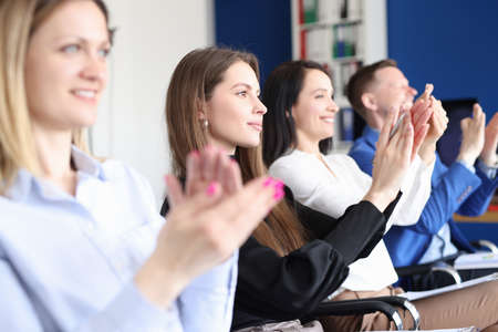 Business people applaud at training conference closeup