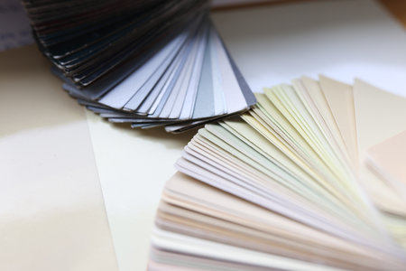 Multi-colored color palettes with swatches lie on tableの写真素材