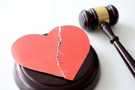 Forensic wooden gavel with red broken heartの写真素材