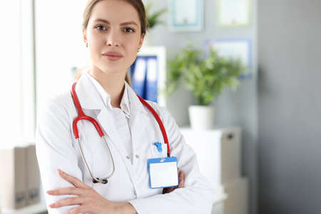Portrait of female doctor in white coat in medical office