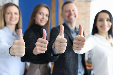 Group of business people showing thumbs up closeupの写真素材