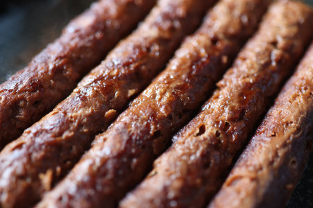 Closeup of grilled meaty appetizing fried sausagesの写真素材