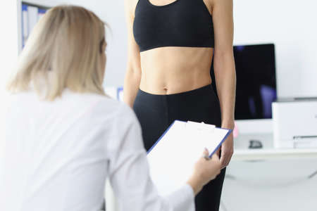 Woman doctor examining patient in clinic closeupの写真素材