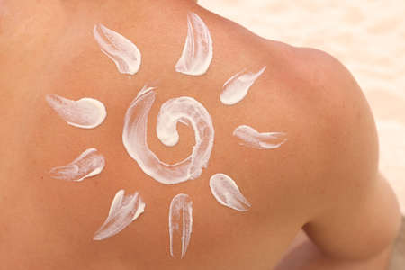 Sun shaped sunscreen is applied to male back