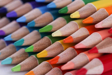 Assortment stack of colored wood drawing pencils closeupの写真素材