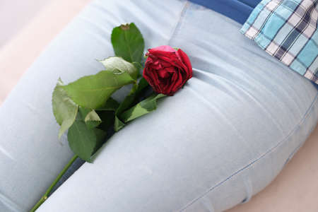 Woman has withered rose in crotch between legsの写真素材