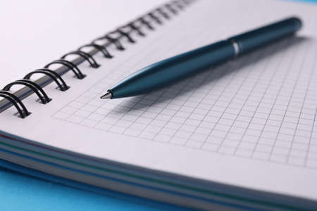 Empty white notebook with pen lie on table closeupの写真素材