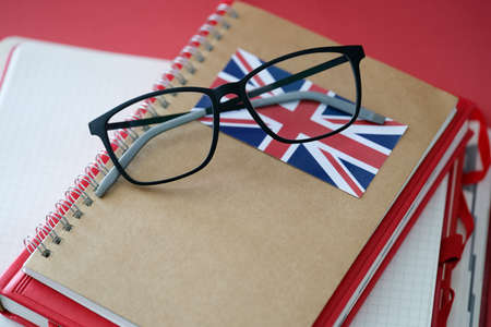 British language textbook and glasses are on tableの写真素材