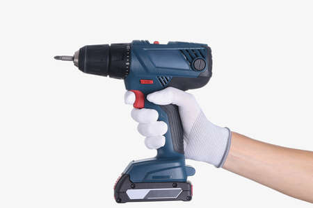 Master in glove holds a drill with drill on white background