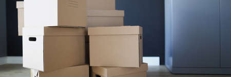 Inside room cardboard boxes on top of each other