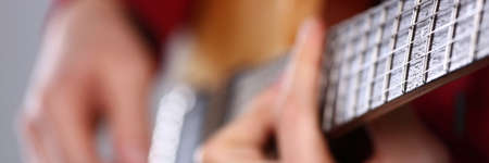 Man playing musical instrument of guitar closeupの写真素材