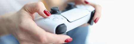 Woman holding joystick for computer game closeup