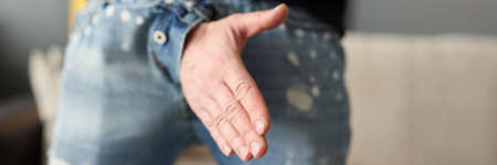 Man offers a handshake through fly of his pantsの写真素材